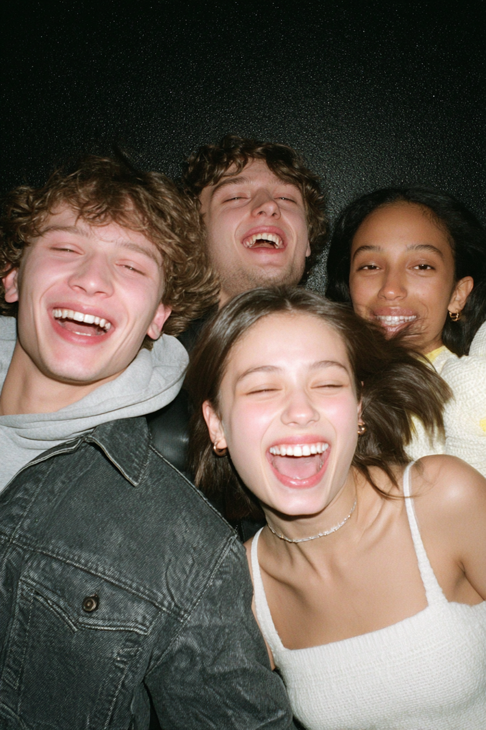 A diverse group of remote team members shares a laugh during an online activity, embodying the lighthearted connection Boggle can foster.
