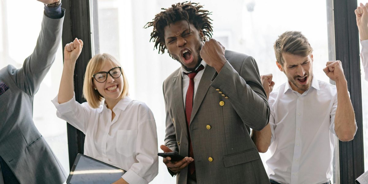 A happy team celebrates a successful project or achievement, feeling accomplished and connected.