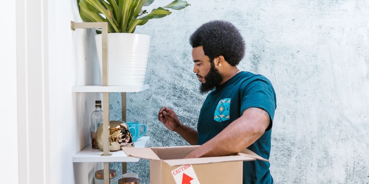 A person actively participates in a virtual scavenger hunt, engaging with their home environment to find an item.