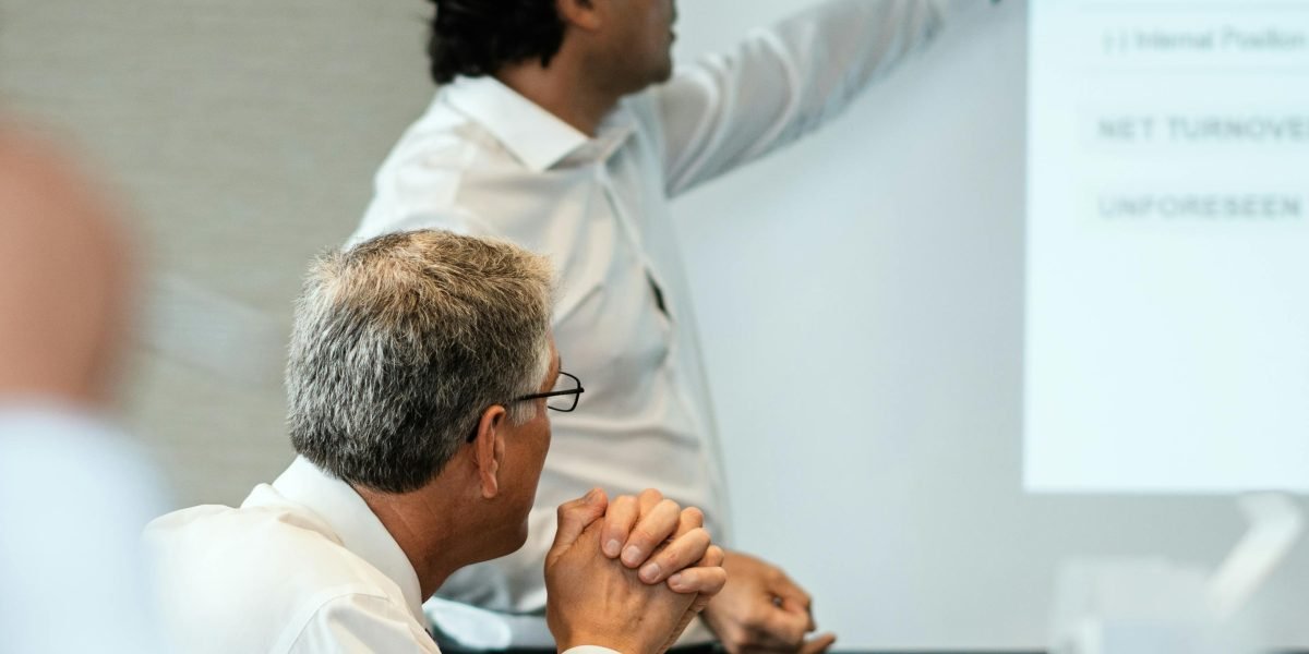 A manager presents options and strategies to a team, illustrating the careful consideration in choosing team-building activities.