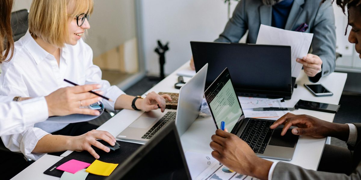 A diverse team engages in cheerful collaboration, symbolizing strong group dynamics.
