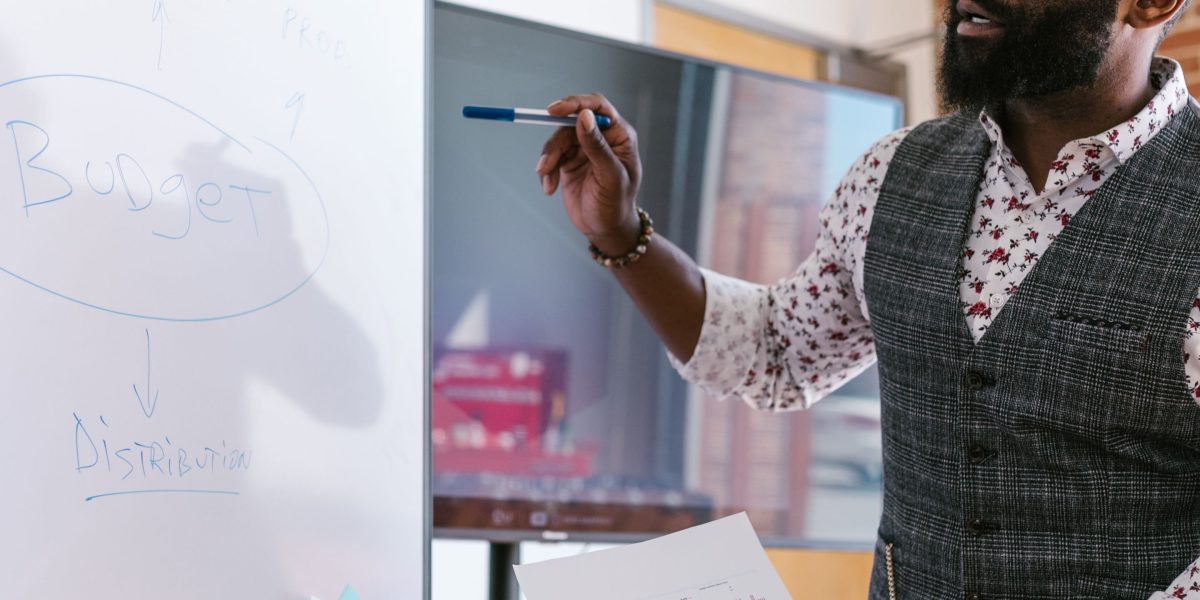 A facilitator leads a debrief session, guiding discussion and encouraging participants to share insights.