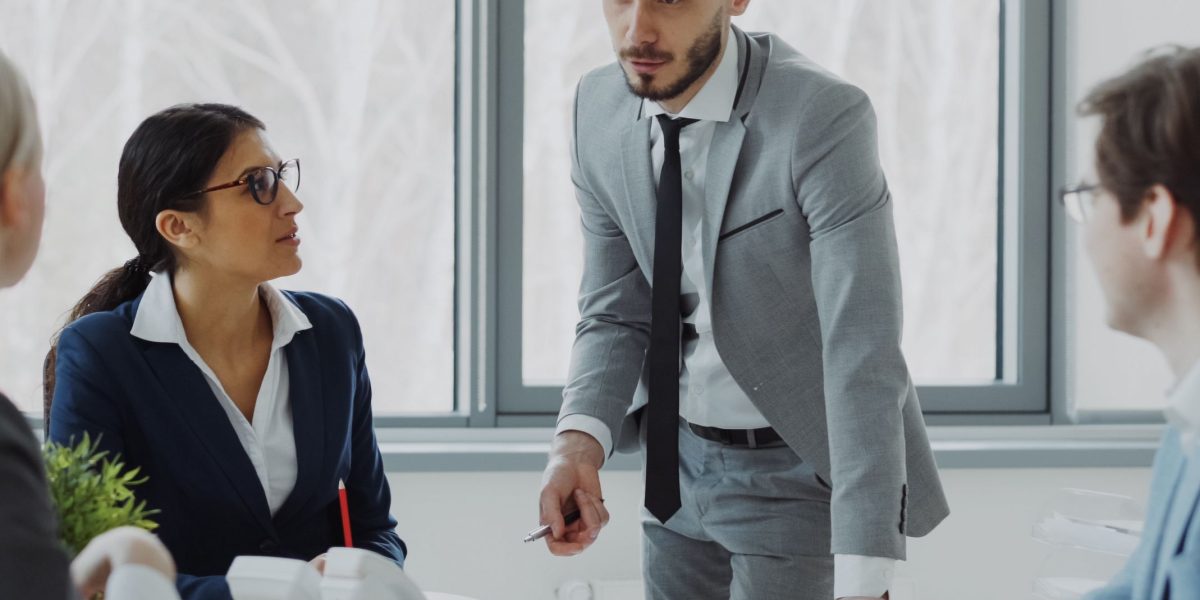 A manager observing and facilitating team interaction during a meeting, noting engagement cues.